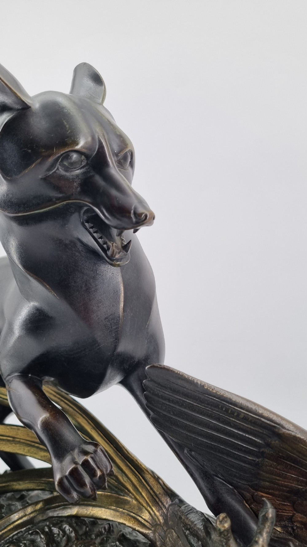 A dark patinated bronze sculpture depicting a fox capturing a pheasant mounted on a black veined marble base. View XI