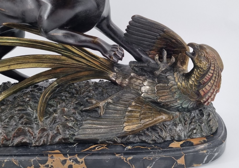 A dark patinated bronze sculpture depicting a fox capturing a pheasant mounted on a black veined marble base. View XIV