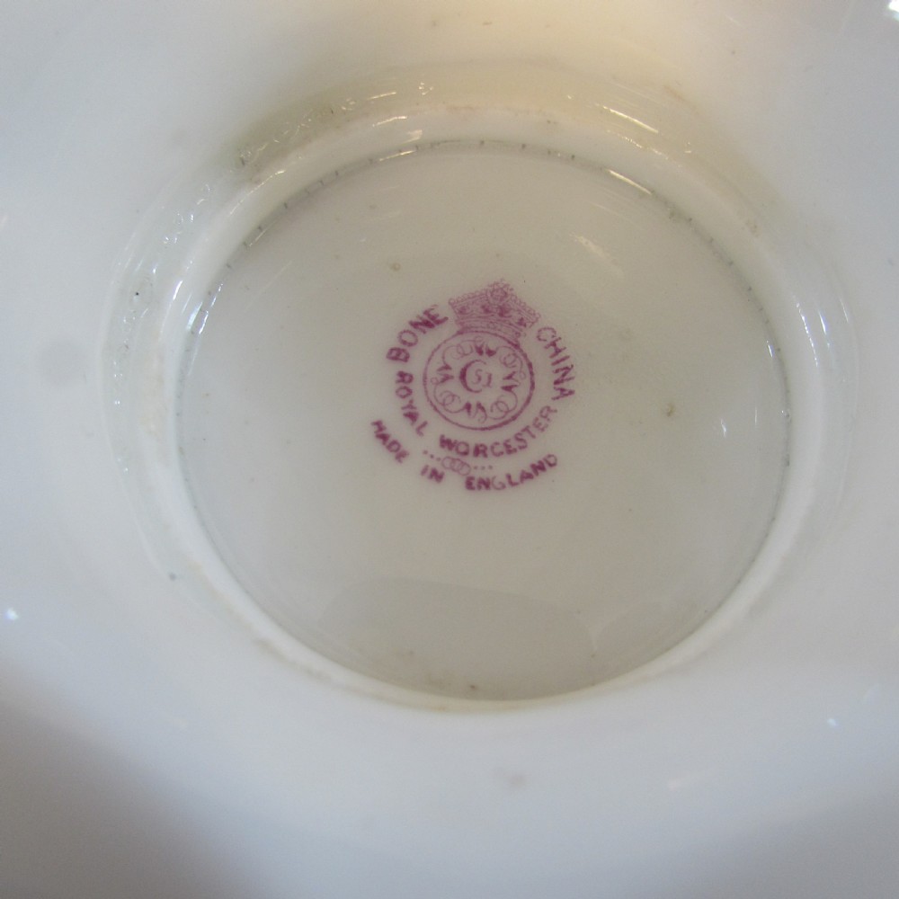An oval hand-painted porcelain comport featuring a motif of blackberries and autumn leaves with gilded handles and a pedestal base. View IV