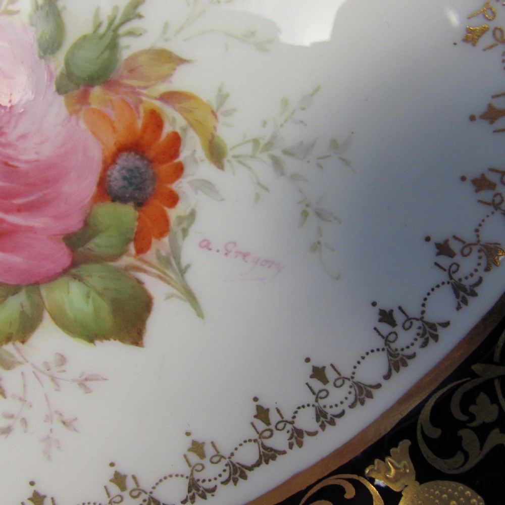 An oval porcelain dish featuring a cobalt blue border, gold scroll decoration, pierced handles, and a central hand-painted floral bouquet reserve. View III