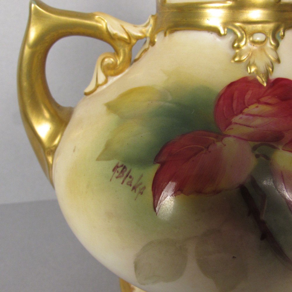 A twin-handled porcelain urn with a finial lid, featuring hand-painted autumn foliage and fruit decoration with rich gilding on the handles, neck, and base. View IV