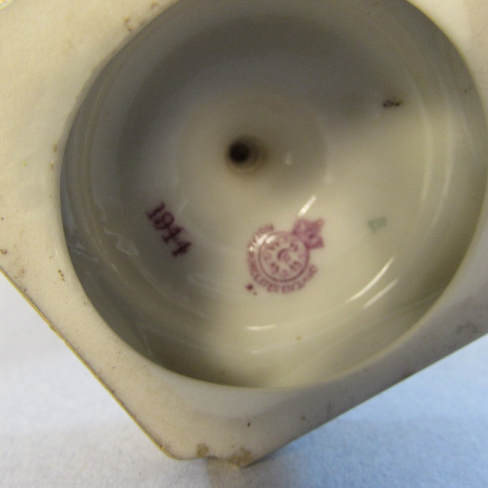 An ornate porcelain ewer featuring a hand-painted scene of Highland cattle, a flared spout, a gilded scroll handle, and a square gold-finished base. View V