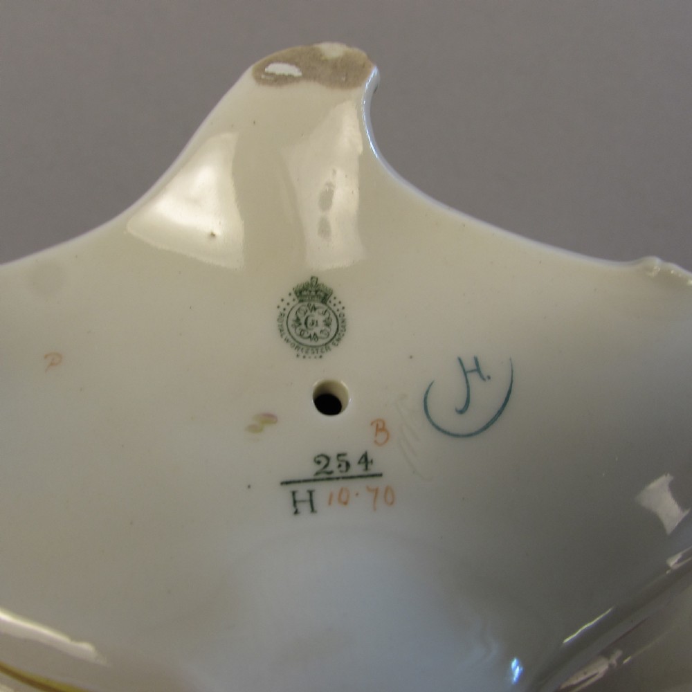 A hand-painted Royal Worcester porcelain centrepiece bowl featuring yellow and red roses, scroll handles, and gilt detailing on a footed base. View V