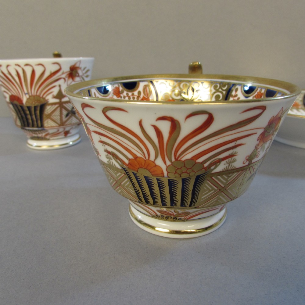A Regency Spode porcelain trio consisting of a teacup, coffee cup, and matching saucer decorated with red, blue, and gold Imari style patterns. View II