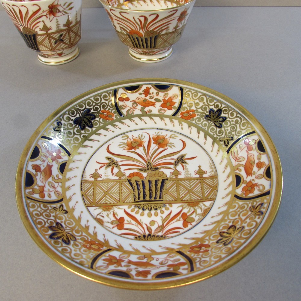 A Regency Spode porcelain trio consisting of a teacup, coffee cup, and matching saucer decorated with red, blue, and gold Imari style patterns. View III