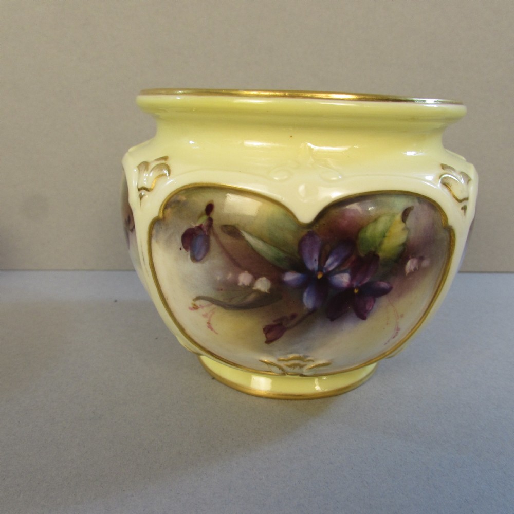 A small pale yellow porcelain vase featuring hand-painted purple flowers within a gold-trimmed shaped panel. View II