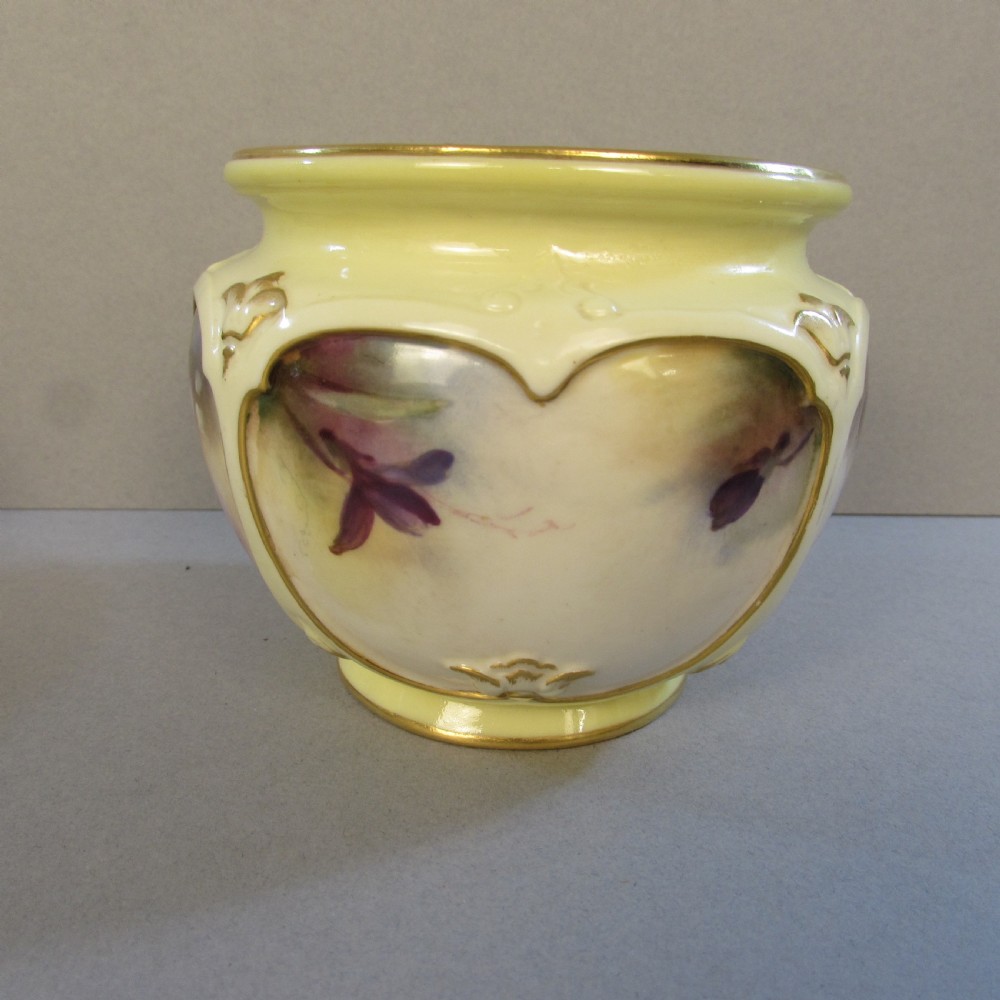 A small pale yellow porcelain vase featuring hand-painted purple flowers within a gold-trimmed shaped panel. View III
