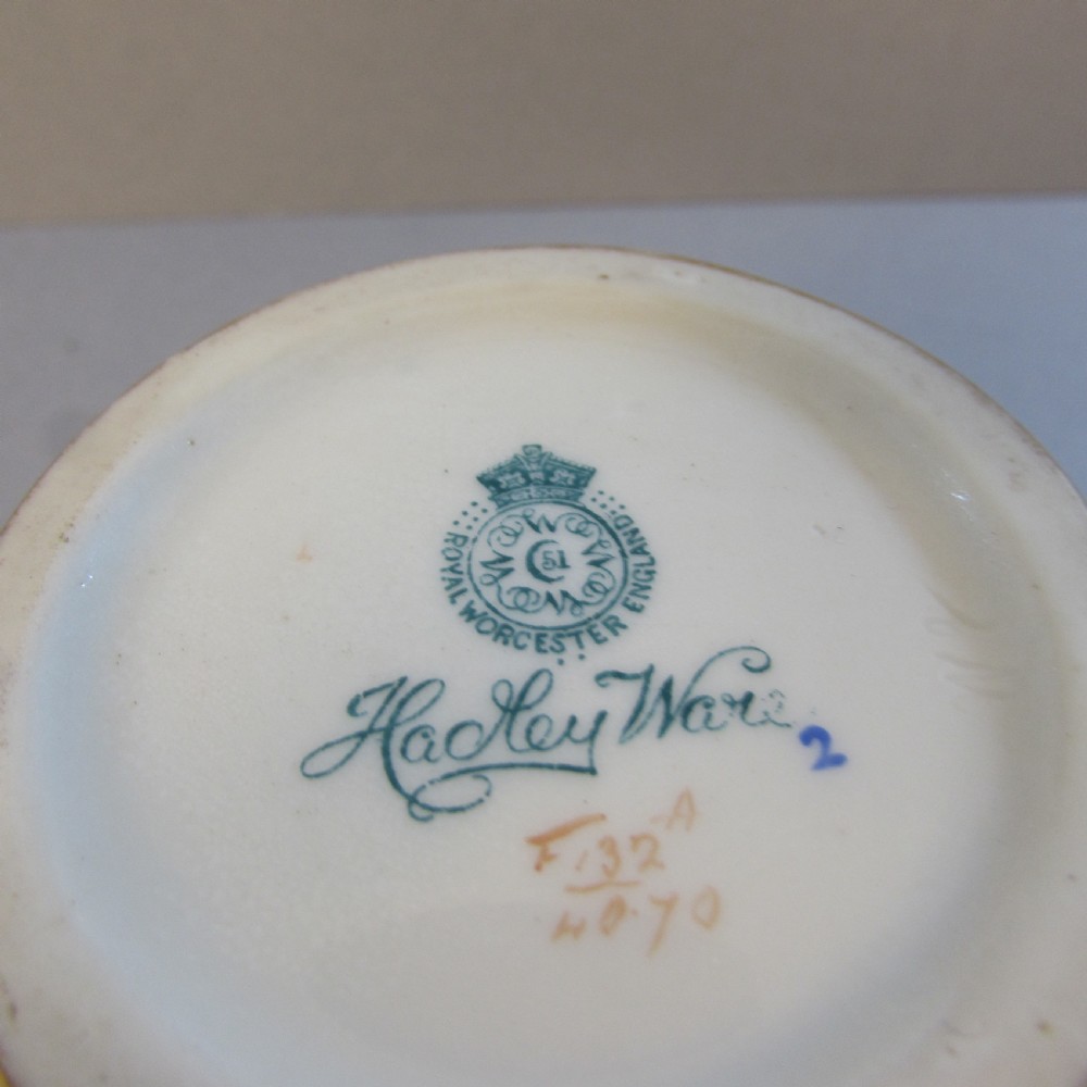 A small pale yellow porcelain vase featuring hand-painted purple flowers within a gold-trimmed shaped panel. View IV