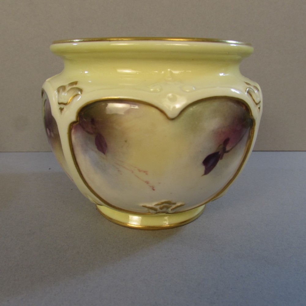 A small pale yellow porcelain vase featuring hand-painted purple flowers within a gold-trimmed shaped panel. View V