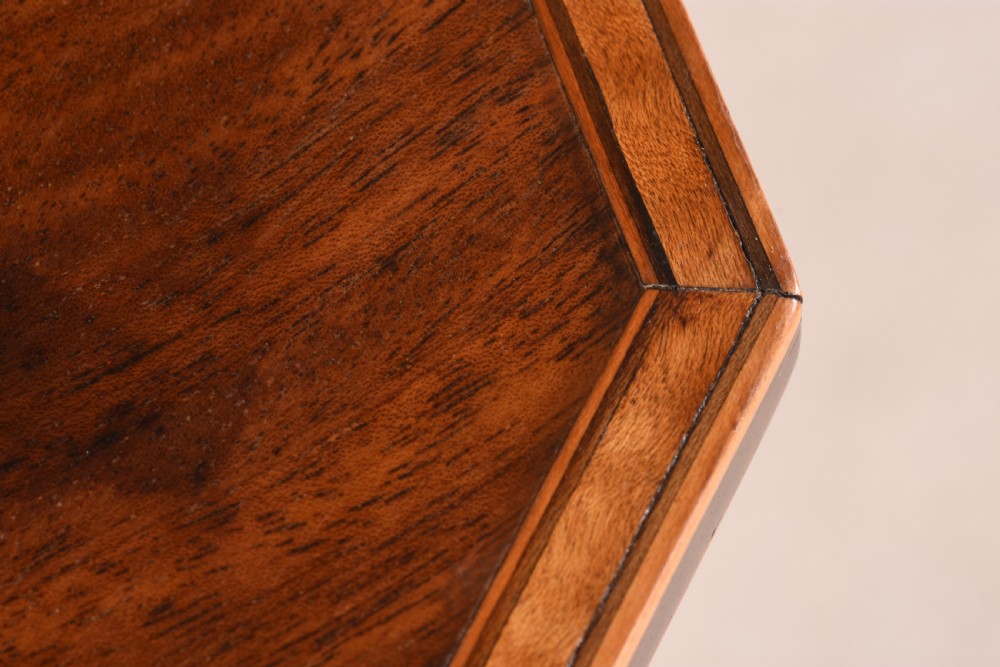 An antique mahogany tripod table featuring an octagonal top with crossbanded inlay, a spiral-twisted central pedestal, and splayed legs terminating in ball feet. View V