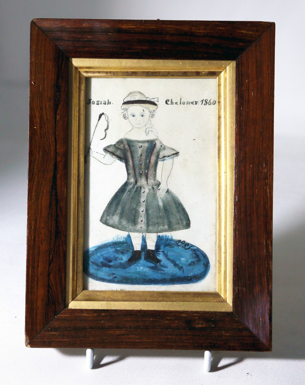 A small 19th-century primitive watercolour portrait of a child named Josiah Chaloner set inside a dark rosewood frame with a gilded inner border.