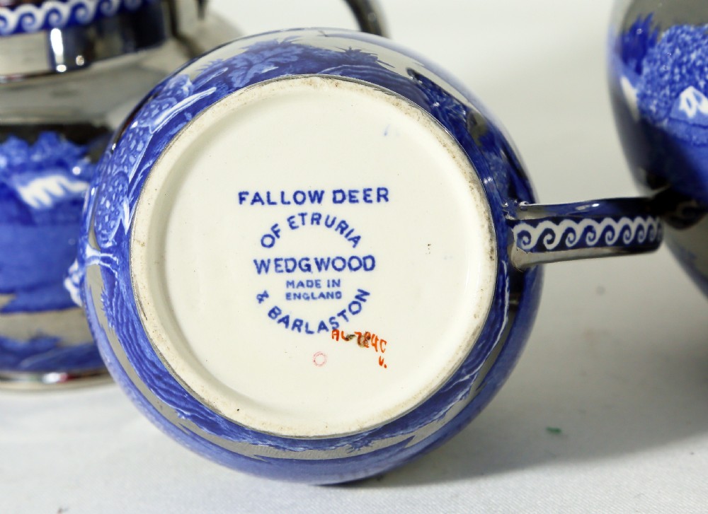 A set of three graduated blue earthenware jugs featuring a silver metallic lustre finish and a transfer-printed landscape scene with a fallow deer. View II