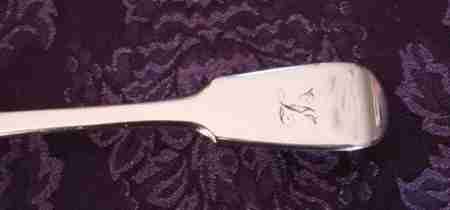 fig 3. A Victorian sterling silver pierced fish slice featuring scrollwork engraving on the blade and a fiddle pattern handle with an engraved monogram.