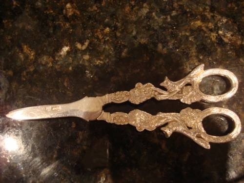 fig 1. A pair of cast sterling silver grape scissors featuring detailed grapevine motifs along the handles.