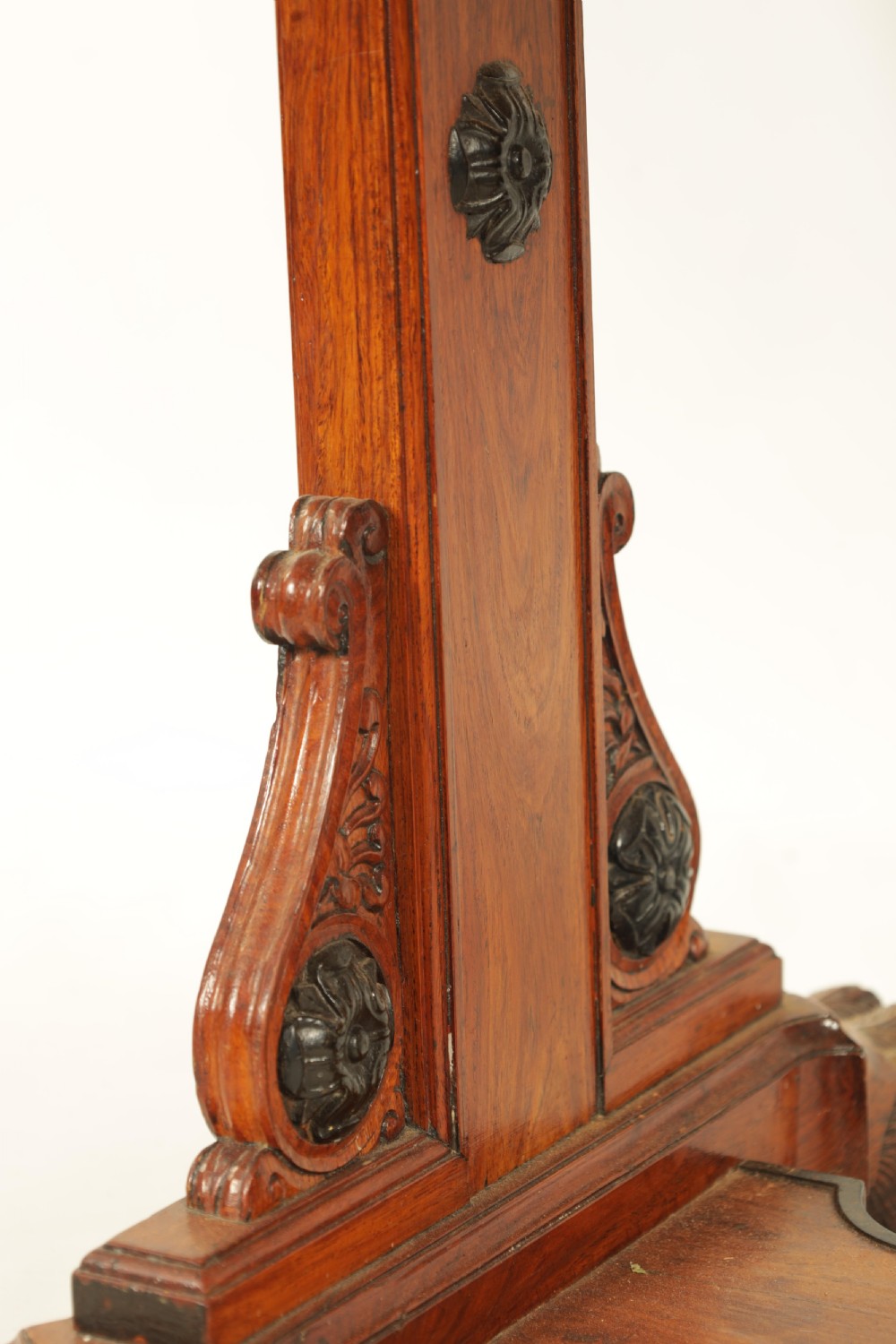 An antique amboyna and rosewood library table featuring a green leather inset top, frieze drawers with brass knobs, trestle legs, and carved lion paw feet. View IV