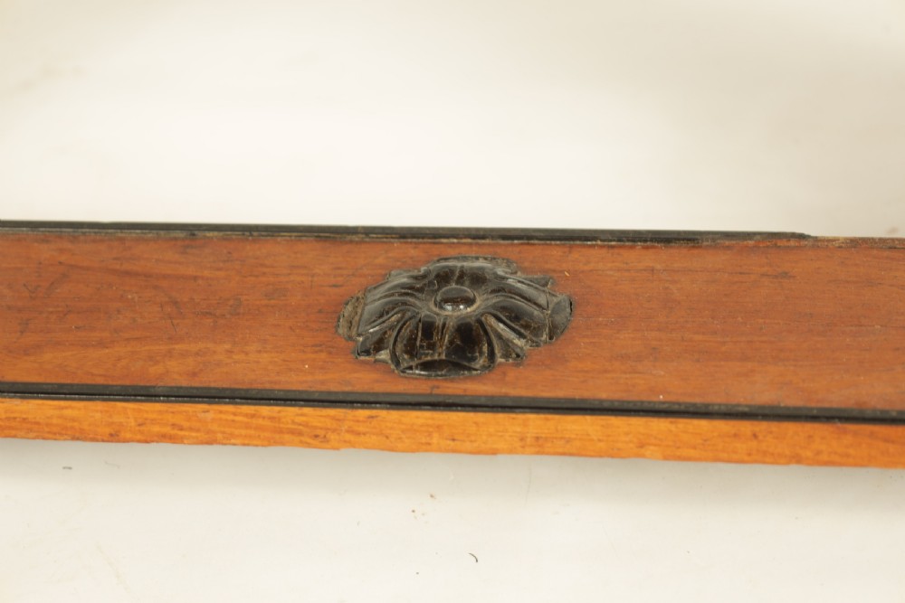 An antique amboyna and rosewood library table featuring a green leather inset top, frieze drawers with brass knobs, trestle legs, and carved lion paw feet. View V