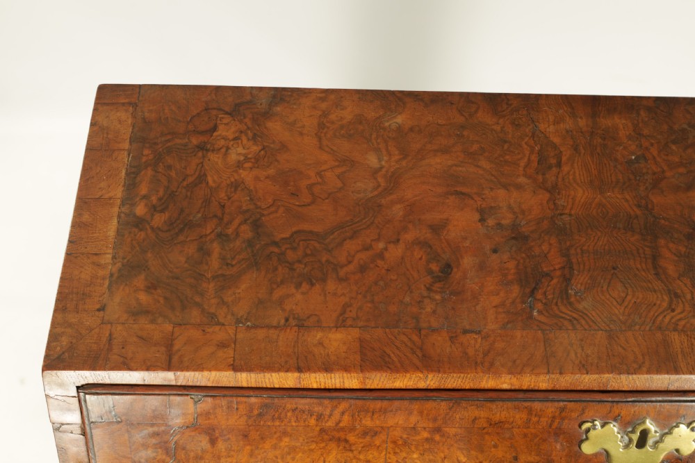 An 18th-century burr walnut bureau featuring a slant-front flap above four graduated drawers with brass handles, resting on bracket feet. View III
