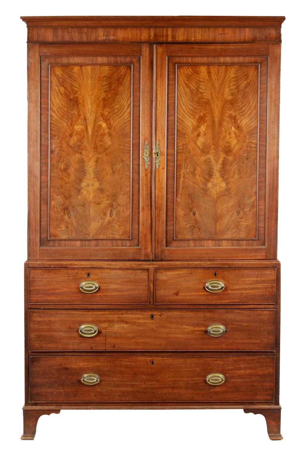 A George III mahogany hanging clothes press featuring two flame mahogany panelled doors over four drawers with brass handles, raised on bracket feet.
