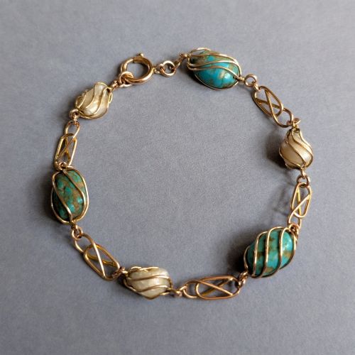 fig 2. An antique 9ct rose gold bracelet featuring alternating wire-caged turquoise and pearl beads connected by openwork links with a bolt ring clasp.
