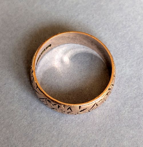 fig 3. An antique 9ct rose gold wedding band featuring hand-engraved star motifs around the exterior circumference.
