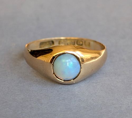 fig 2. An antique yellow gold gypsy ring featuring a central round cabochon opal with blue and orange play-of-colour.