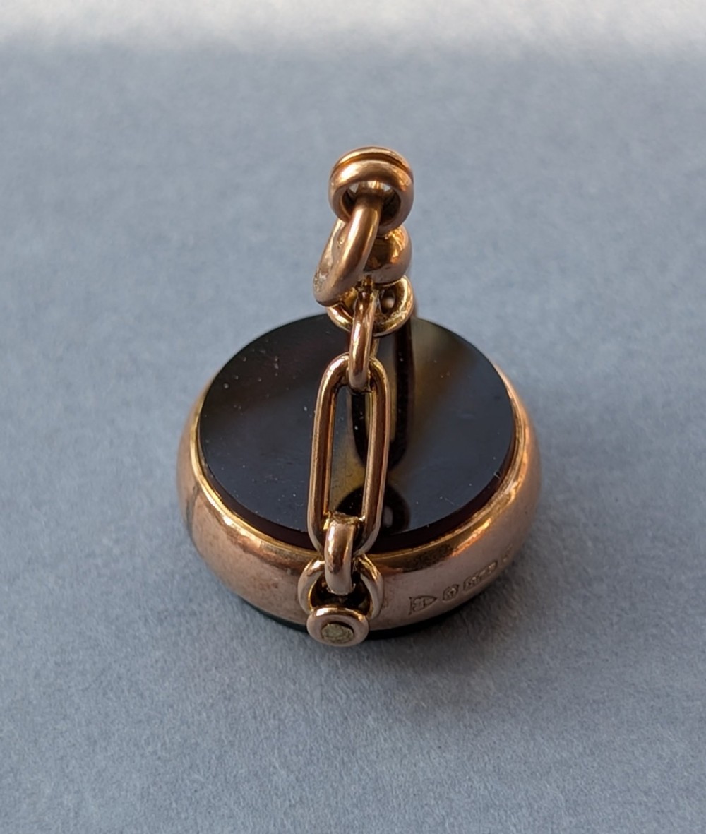 An Edwardian 9ct gold spinning fob pendant set with a polished circular dark green bloodstone gemstone with red flecks. View III