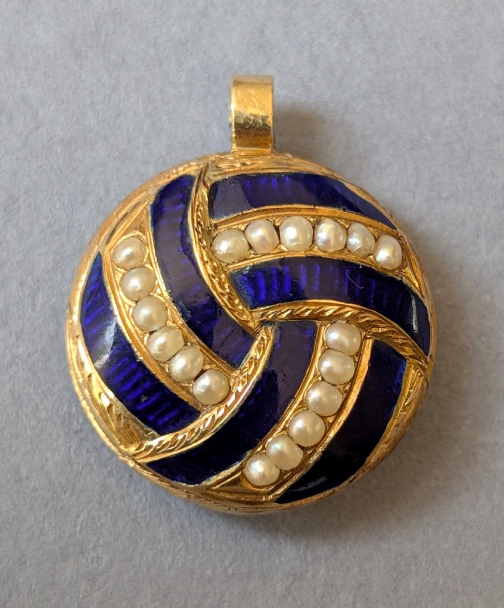 A circular Victorian gold pendant featuring spiralling bands of cobalt blue enamel and set split pearls. View III