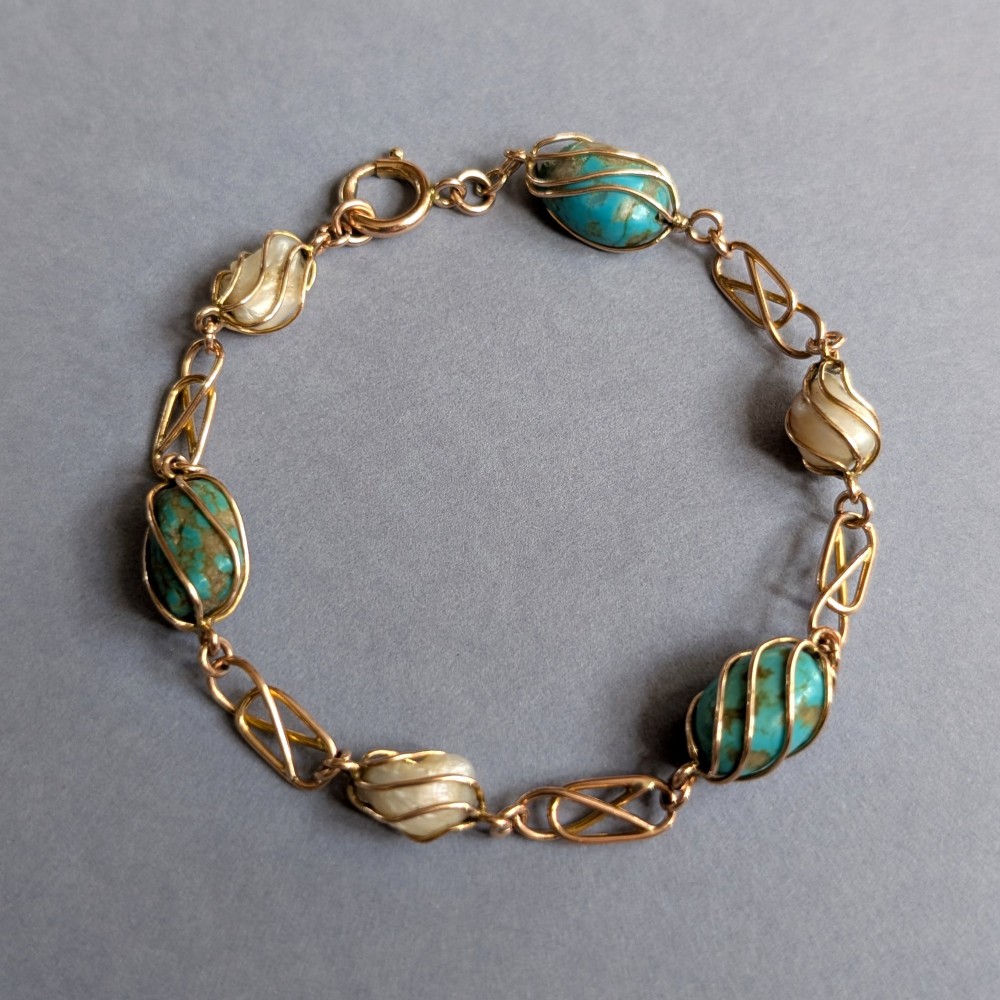 An antique 9ct rose gold bracelet featuring alternating wire-caged turquoise and pearl beads connected by openwork links with a bolt ring clasp. View III