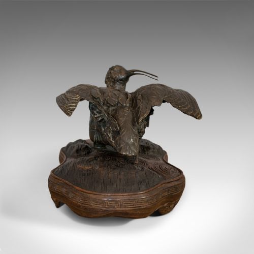 fig 1. An antique bronze sculpture depicting a curlew bird with outstretched wings, set upon a carved mahogany base.