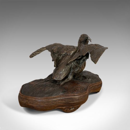 fig 2. An antique bronze sculpture depicting a curlew bird with outstretched wings, set upon a carved mahogany base.