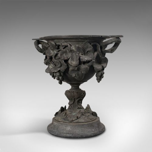 fig 2. An 18th-century Continental dark bronze serving cup featuring detailed grapevine relief carving, twin side handles, and a flared pedestal base.