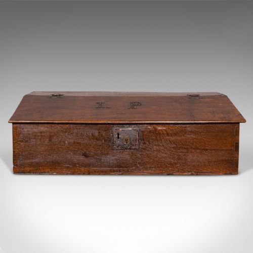 fig 2. A dark brown antique oak tabletop writing desk featuring a sloped hinged lid with studded initials and a metal front lockplate.