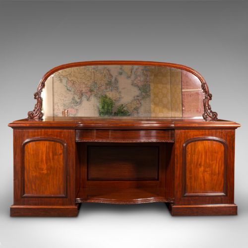 fig 1. A Victorian flame mahogany pedestal sideboard featuring a large arched mirror back with carved scroll supports above twin panelled pedestal cupboards.
