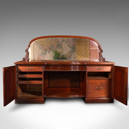fig 2. A Victorian flame mahogany pedestal sideboard featuring a large arched mirror back with carved scroll supports above twin panelled pedestal cupboards.