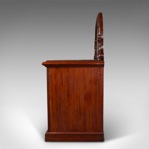 fig 3. A Victorian flame mahogany pedestal sideboard featuring a large arched mirror back with carved scroll supports above twin panelled pedestal cupboards.