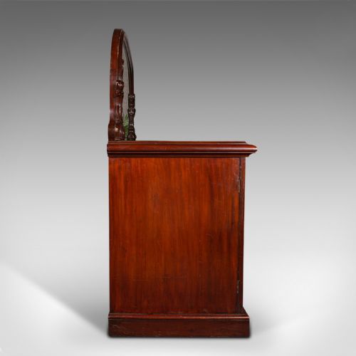 fig 5. A Victorian flame mahogany pedestal sideboard featuring a large arched mirror back with carved scroll supports above twin panelled pedestal cupboards.