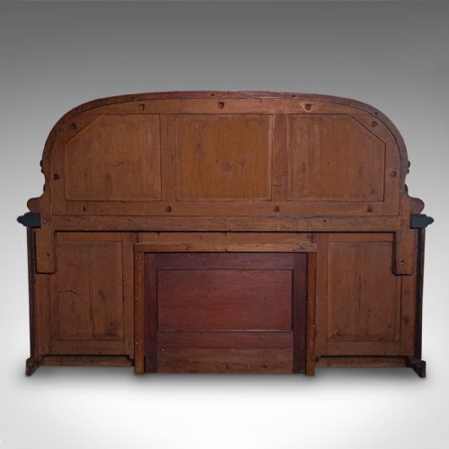 fig 6. A Victorian flame mahogany pedestal sideboard featuring a large arched mirror back with carved scroll supports above twin panelled pedestal cupboards.