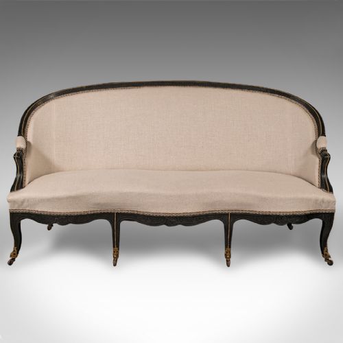 fig 1. A 19th-century Continental Louis XV style ebonised settee upholstered in neutral linen with gilt accents and cabriole legs on castors.