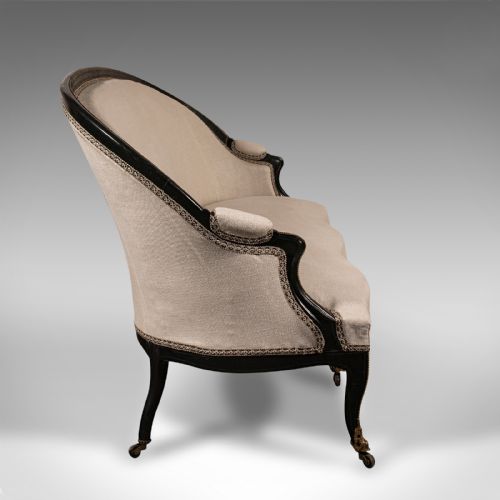 fig 2. A 19th-century Continental Louis XV style ebonised settee upholstered in neutral linen with gilt accents and cabriole legs on castors.