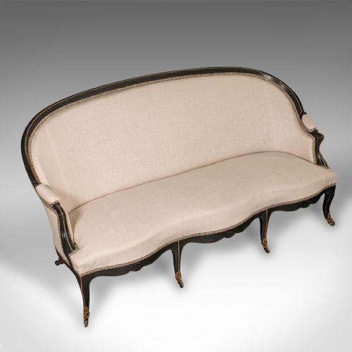 fig 5. A 19th-century Continental Louis XV style ebonised settee upholstered in neutral linen with gilt accents and cabriole legs on castors.