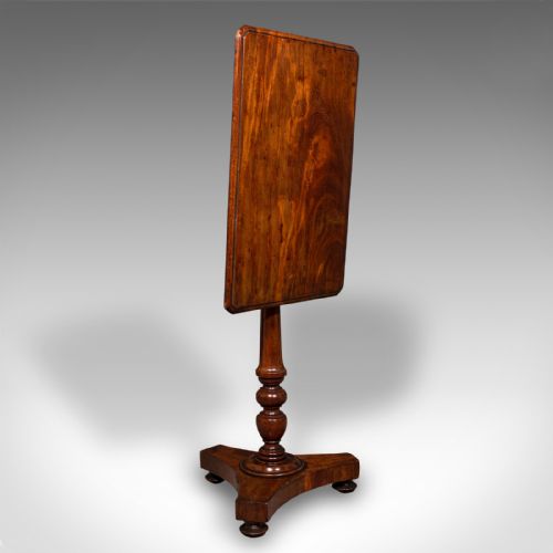 fig 1. A Regency flame mahogany tilting lamp table featuring a rectangular top, turned pedestal stem, and tri-form base.