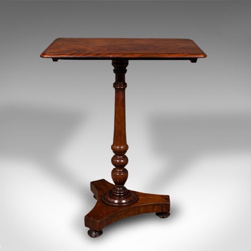 fig 2. A Regency flame mahogany tilting lamp table featuring a rectangular top, turned pedestal stem, and tri-form base.