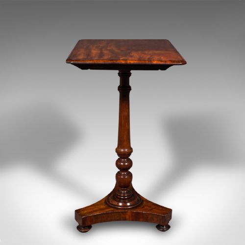 fig 4. A Regency flame mahogany tilting lamp table featuring a rectangular top, turned pedestal stem, and tri-form base.