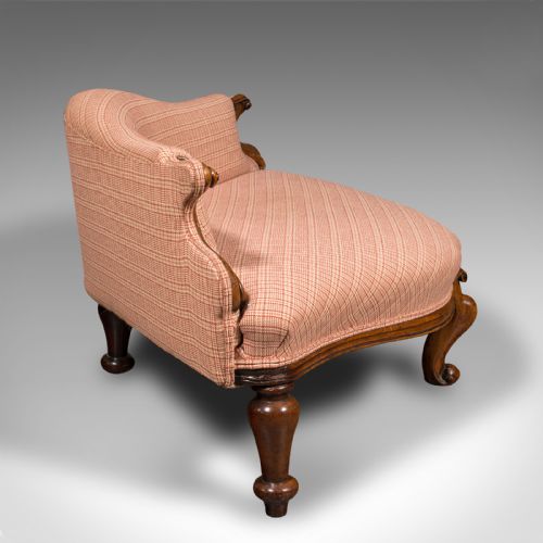 fig 2. A Victorian asymmetrical walnut love seat featuring a carved wood frame and red patterned fabric upholstery.