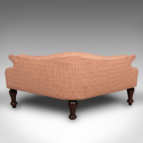 fig 3. A Victorian asymmetrical walnut love seat featuring a carved wood frame and red patterned fabric upholstery.