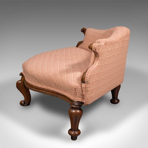 fig 4. A Victorian asymmetrical walnut love seat featuring a carved wood frame and red patterned fabric upholstery.