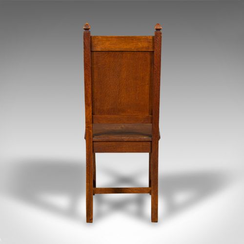 fig 3. A pair of antique Victorian English oak hall chairs featuring carved IHS monograms on the backrests and solid wooden seats.