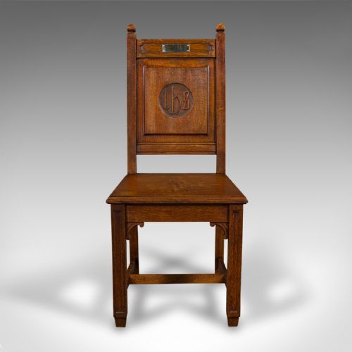 fig 4. A pair of antique Victorian English oak hall chairs featuring carved IHS monograms on the backrests and solid wooden seats.
