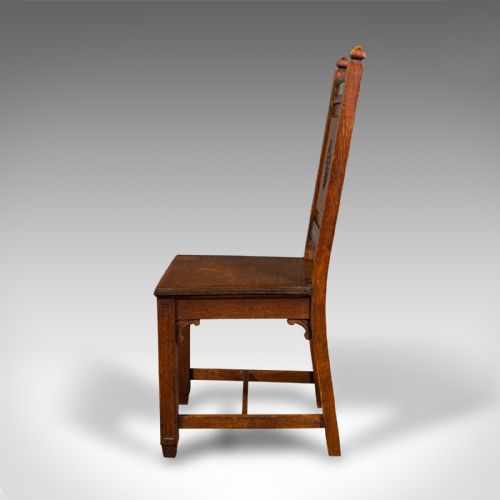 fig 5. A pair of antique Victorian English oak hall chairs featuring carved IHS monograms on the backrests and solid wooden seats.