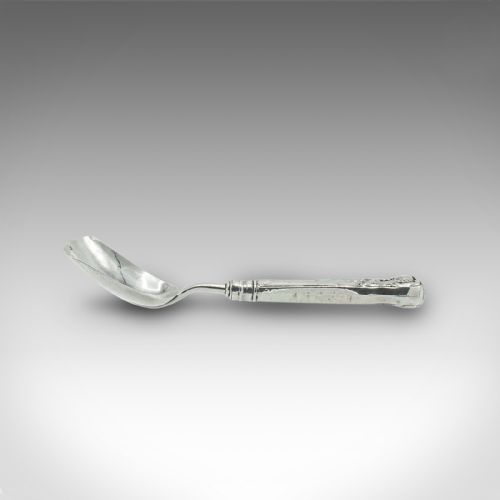 fig 2. An 18th-century English sterling silver sugar spoon featuring a square shovel-shaped bowl and a shell motif handle.